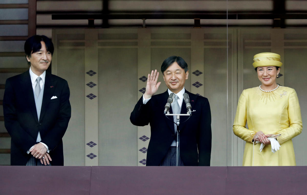 Japan's Crown Prince Akishino looks on as Emperor Naruhito and Empress Masako greet well-wishers during their first public appearance at the Imperial Palace in Tokyo. Reuters