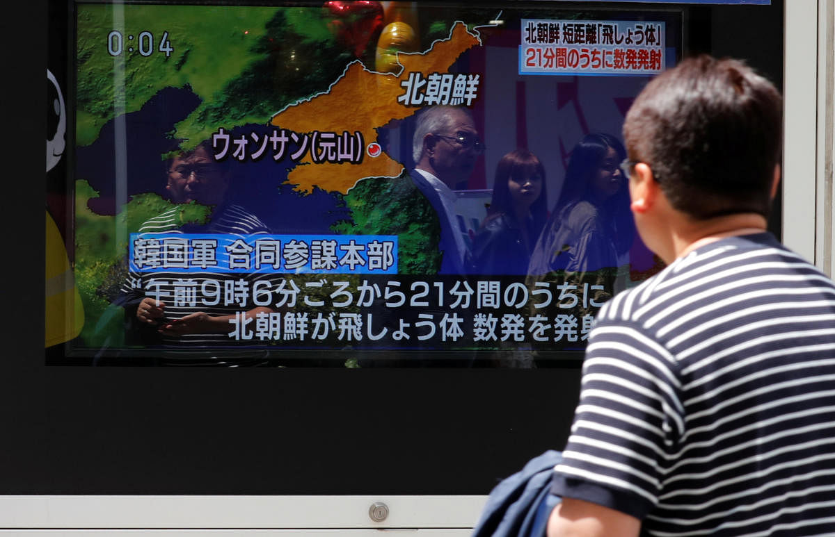 A man watches a television screen showing a news report on North Korea firing several short-range projectiles from its east coast, on a street in Tokyo. Reuters