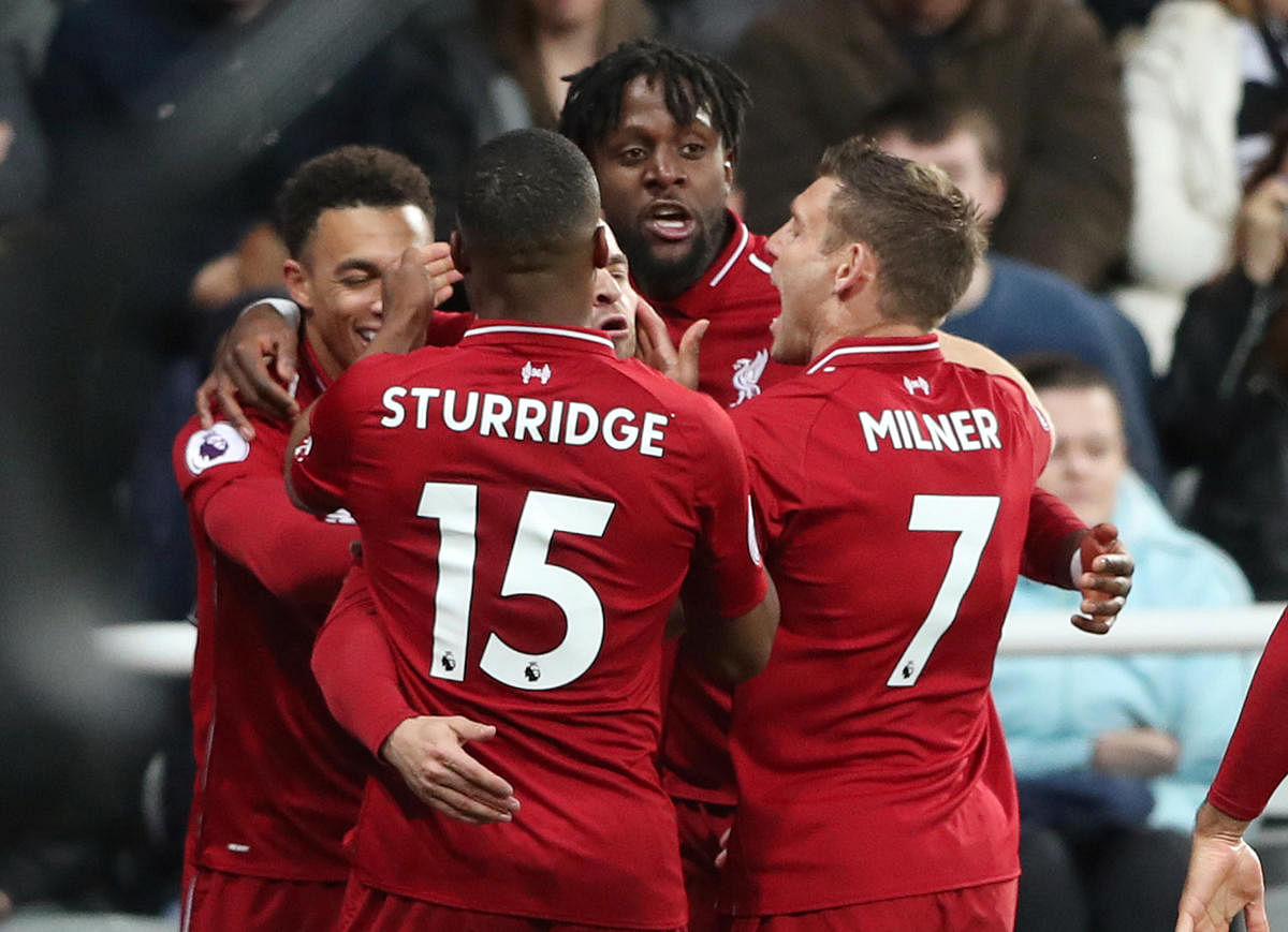 Never back down: Liverpool's Divock Origi (second from right) celebrates with team-mates after scoring the winner against Newcastle United on Saturday. REUTERS