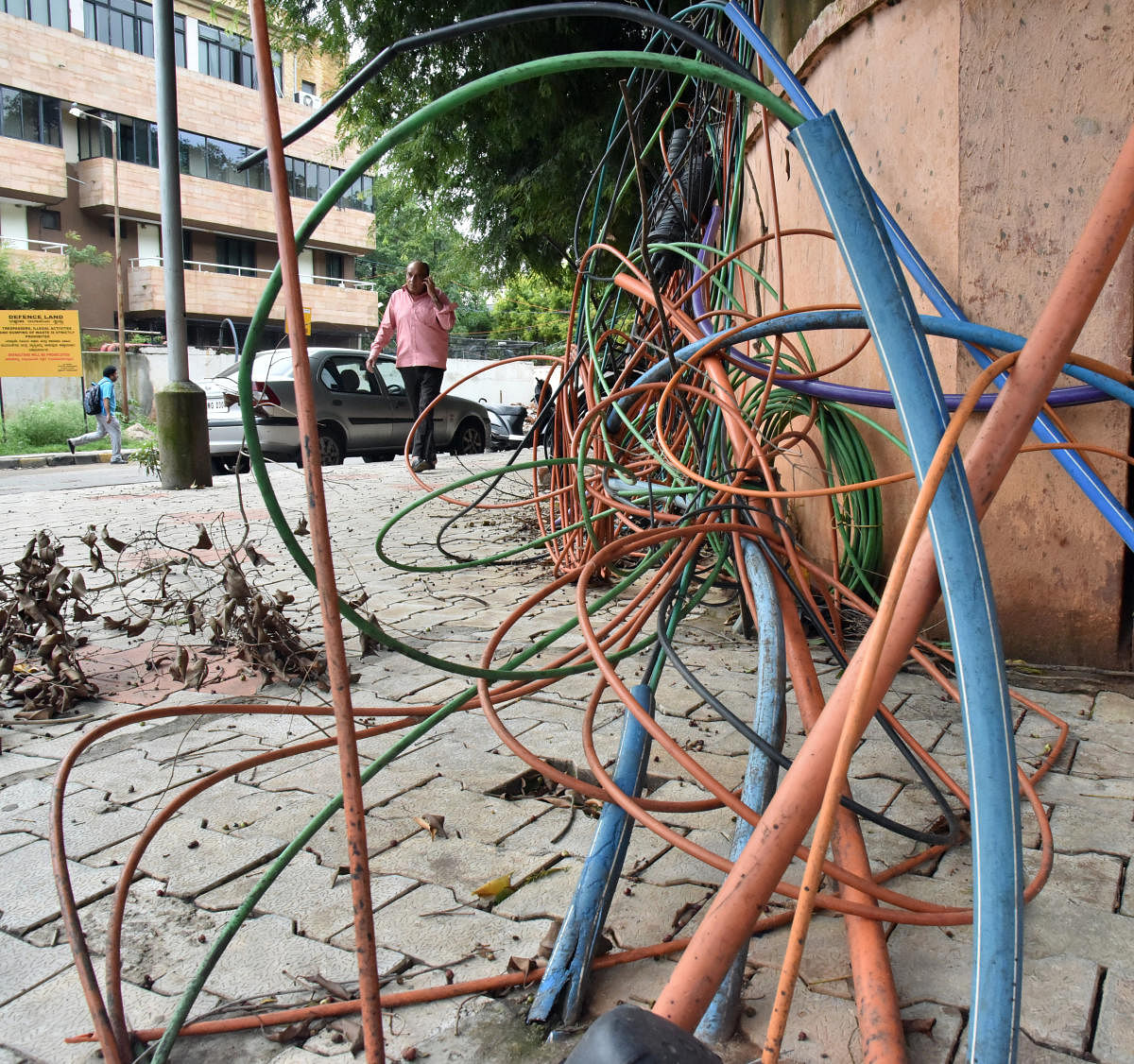 While officials say cables can be installed only underground, it's common to find OFCs strewn on city streets. DH FILE PHOTO