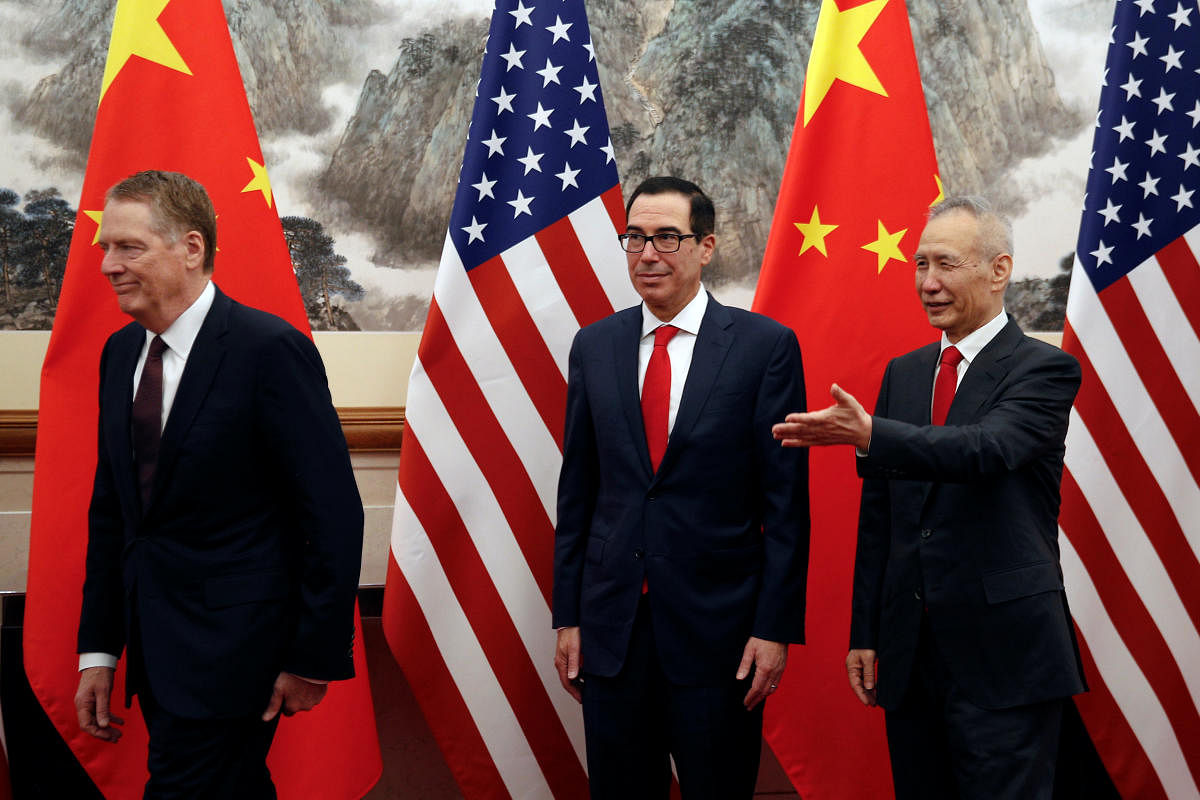 Chinese Vice Premier Liu He, right, shows the way to U.S. Treasury Secretary Steven Mnuchin, center, and U.S. Trade Representative Robert Lighthizer, left, as they proceed to their meeting at the Diaoyutai State Guesthouse in Beijing. (Reuters File Photo)