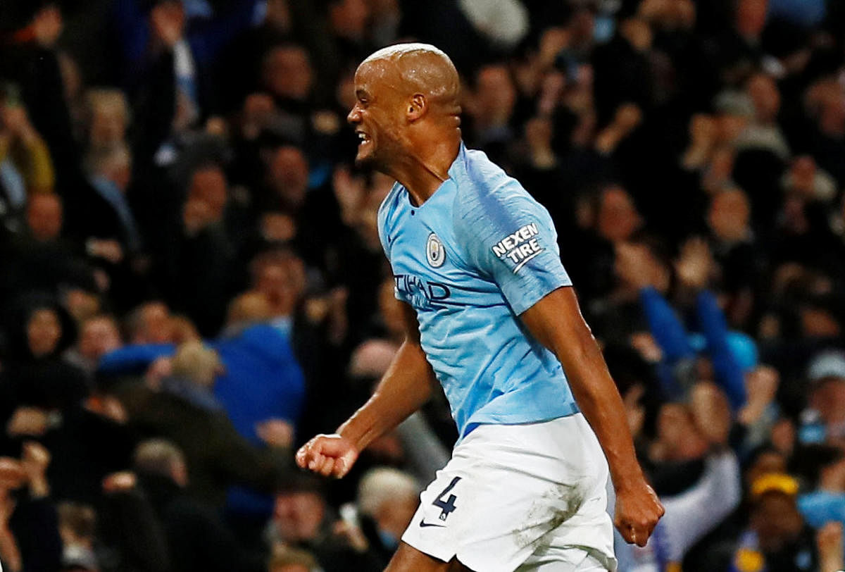 Manchester City captain Vincent Kompany (right) celebrates scoring the winner against Leicester City on Monday. AFP