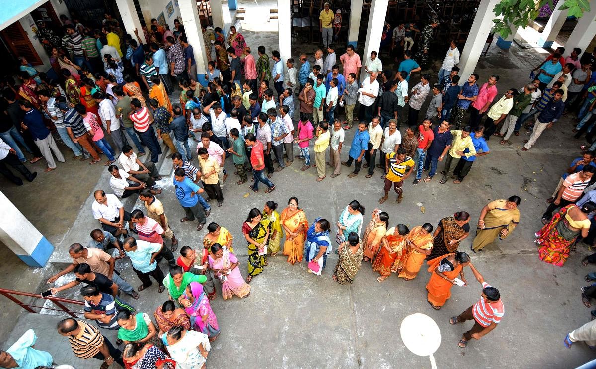 Voters queue at a polling station to cast their ballots during the fifth phase of General election in Howrah in West Bengal. AFP photo