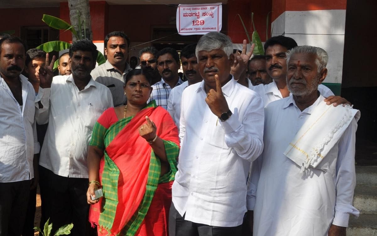 Minister C S Puttaraju and his wife Nagamma cast their vote at Chinnakurali village, Pandavapura taluk, Mandya district on Thursday.