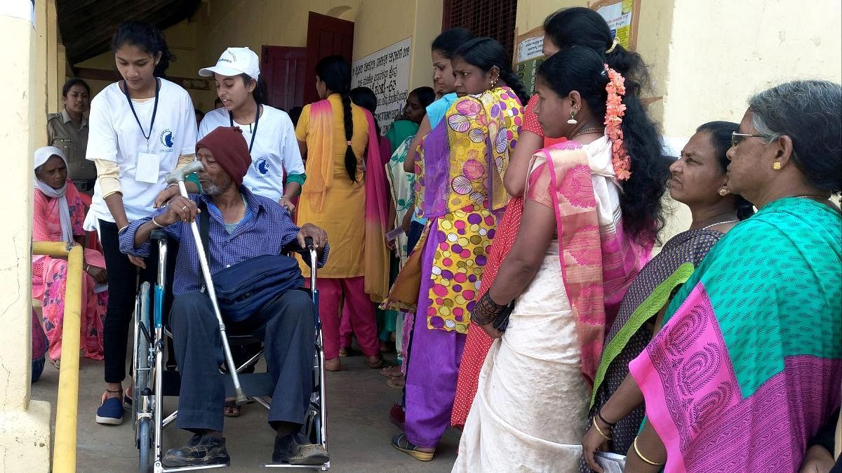 Venkatesh, a patient suffering from paralysis, exercised his franchise at the polling booth at the Government Junior College, Somwarpet.