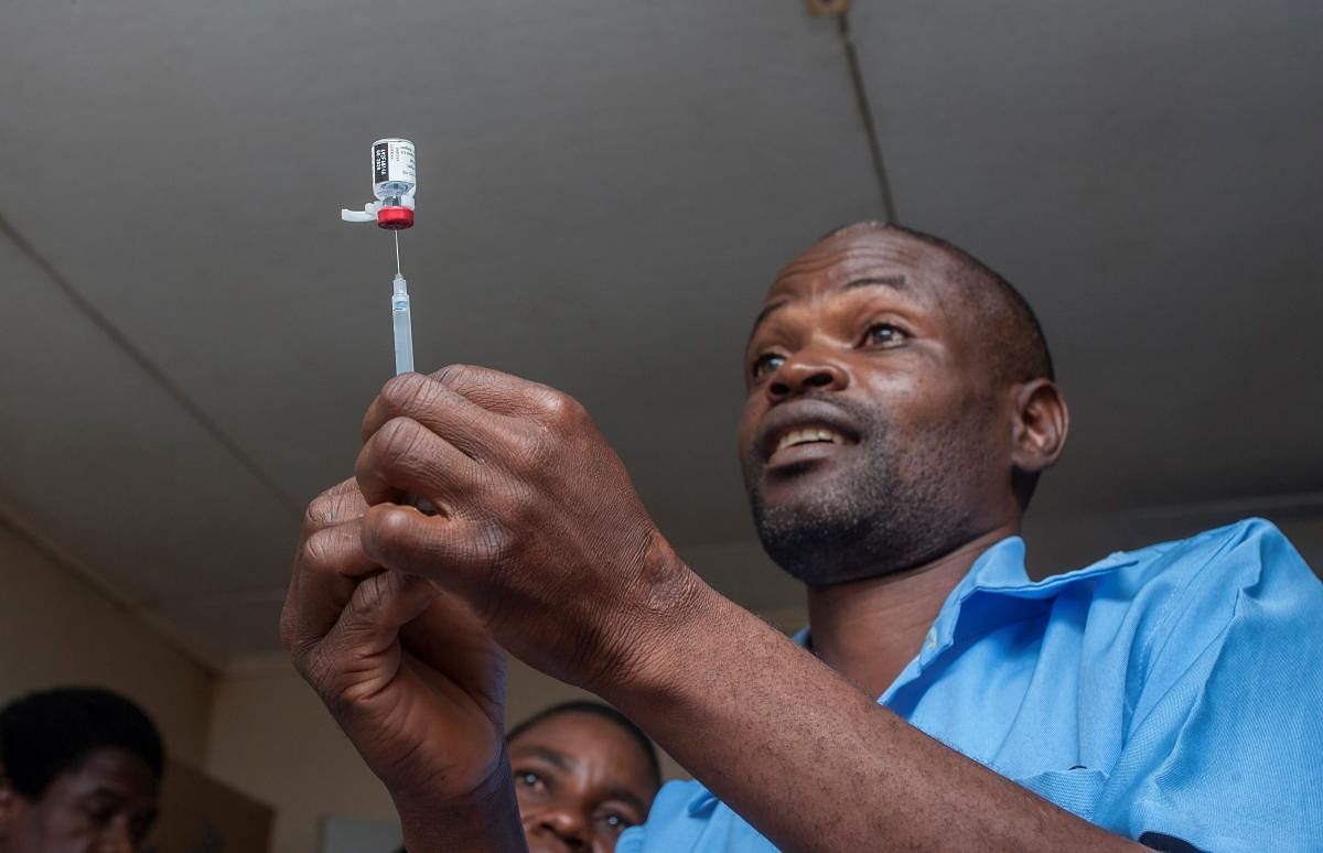A health surveillance assistant (HAS) gets malaria vaccine from its bottle into an injection to be administered to a child at the beginning of the Malaria vaccine implementation pilot programme at Mitundu Community hospital in Malawi's capital district of