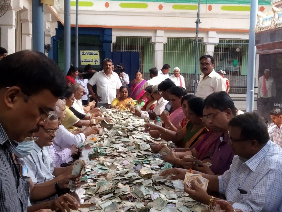 The authorities at the Ghati Subramanya Swamy Temple count the offerings from devotees.