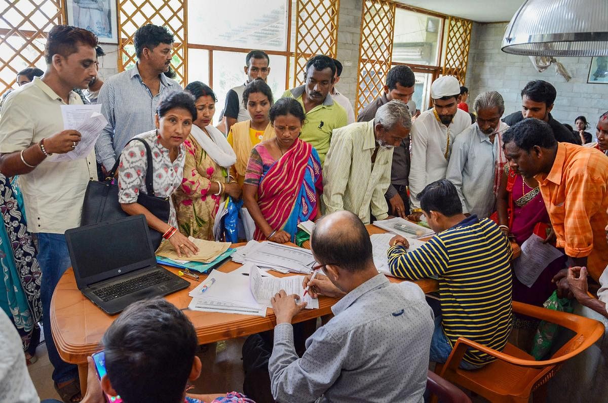 People check their names in the National Register of Citizens (NRC) list during a hearing at a Seva Kendra, in Guwahati, Tuesday, May 07, 2019. (PTI Photo)