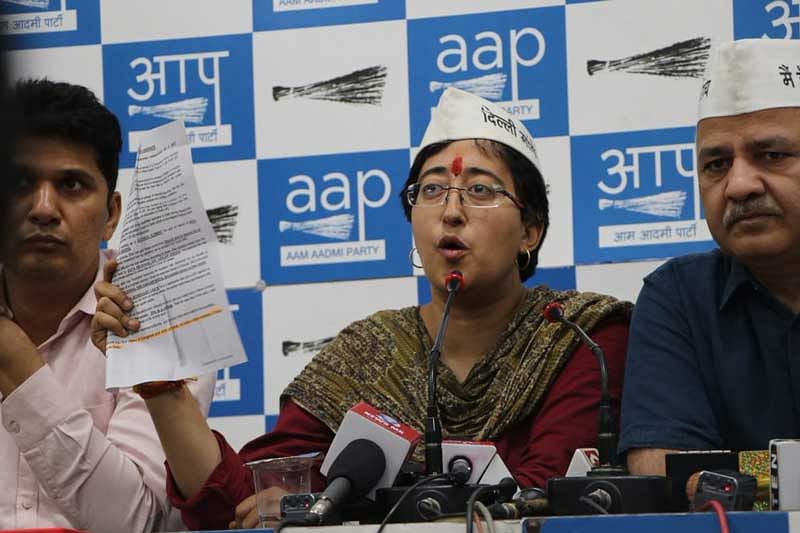 Atishi, who was accompanied by Deputy Delhi Chief Minister Manish Sisodia during a press conference, broke down as she read out the pamphlet in front of reporters. Image courtesy: ANI/Twitter