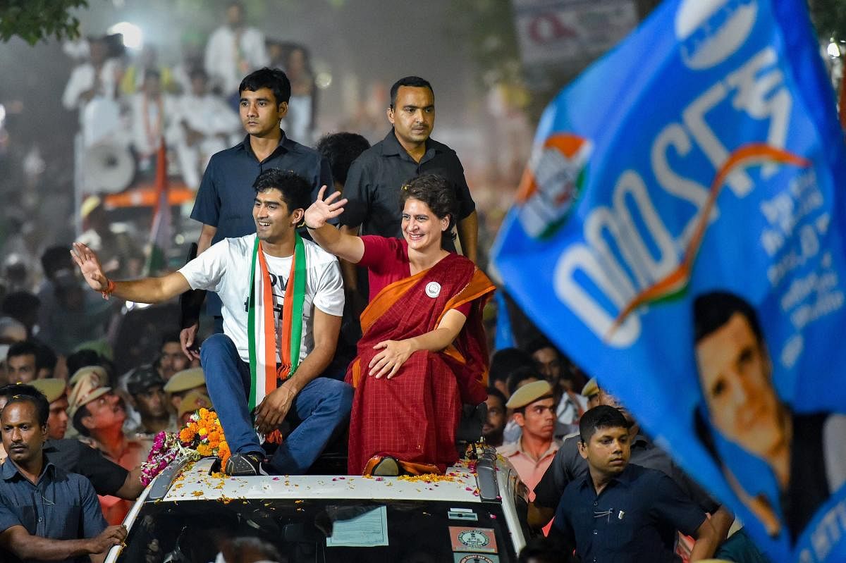 Congress General Secretary Priyanka Gandhi Vadra with party's South Delhi candidate boxer Vijender Singh waves at supporters during an election campaign roadshow for the Lok Sabha polls, in New Delhi. PTI photo