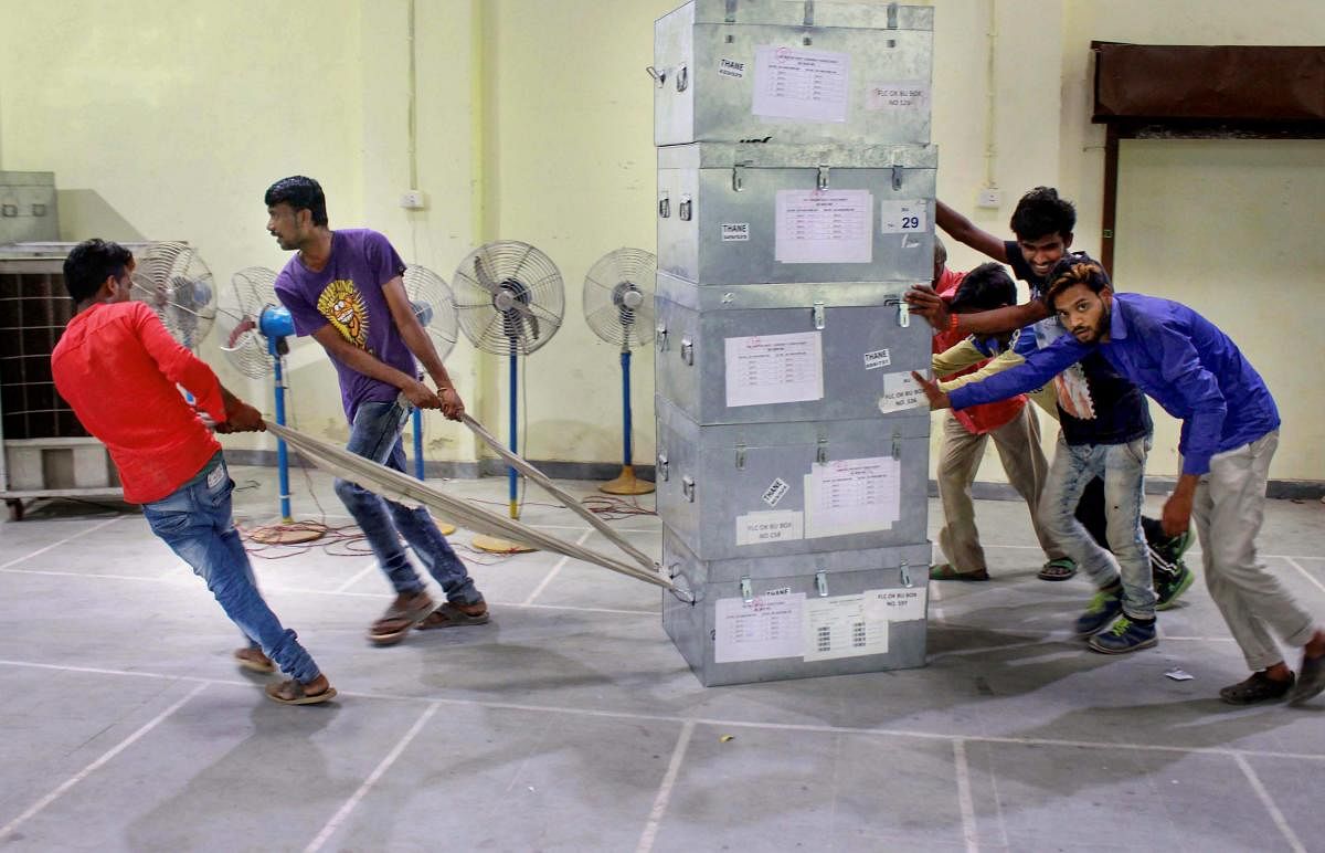 Workers shift election material at a distribution centre for the upcoming Lok Sabha elections in Thane on Wednesday. PTI