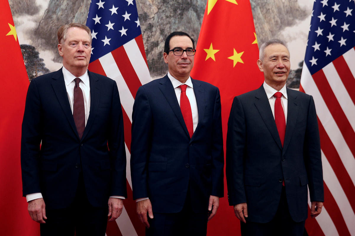 Chinese Vice Premier Liu He, right, poses with U.S. Treasury Secretary Steven Mnuchin, center, and U.S. Trade Representative Robert Lighthizer, left, before they proceed to their meeting at the Diaoyutai State Guesthouse in Beijing. Reuters file photo.