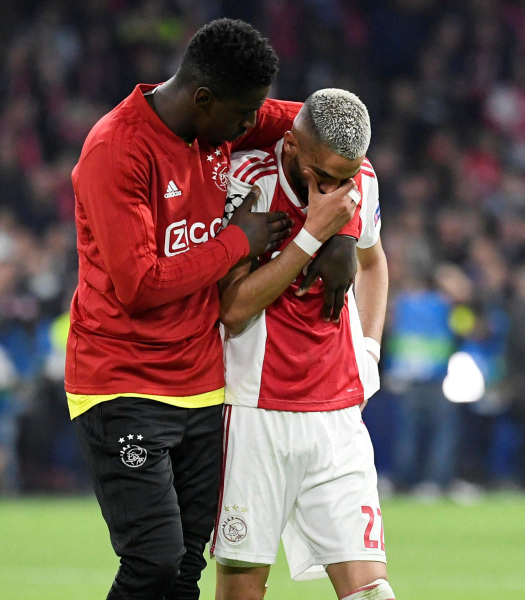 GUTTED: Hakim Ziyech (right) is consoled by a team-mate after Ajax's heartbreaking defeat to Tottenham Hotspur in the second leg of the UEFA Champions League semifinals on Wednesday. Reuters.