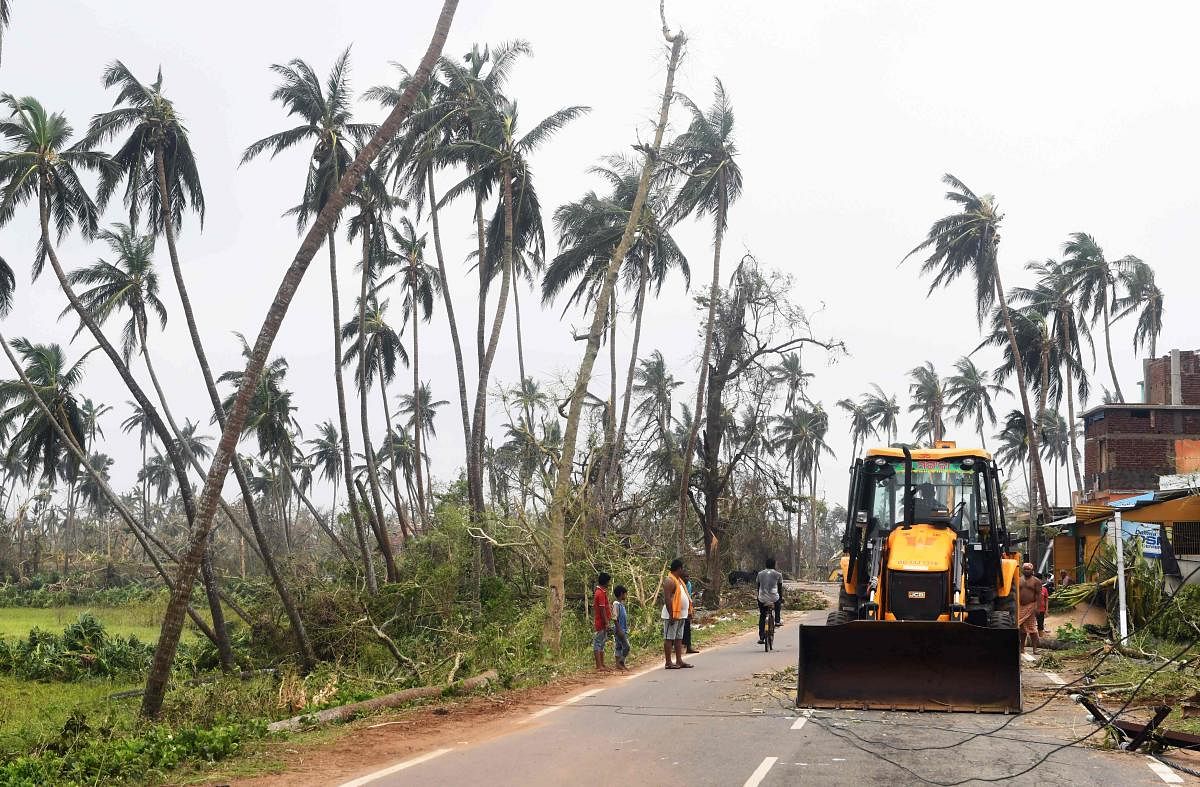 The earth movers vehicle clear the road in Puri. AFP file photo