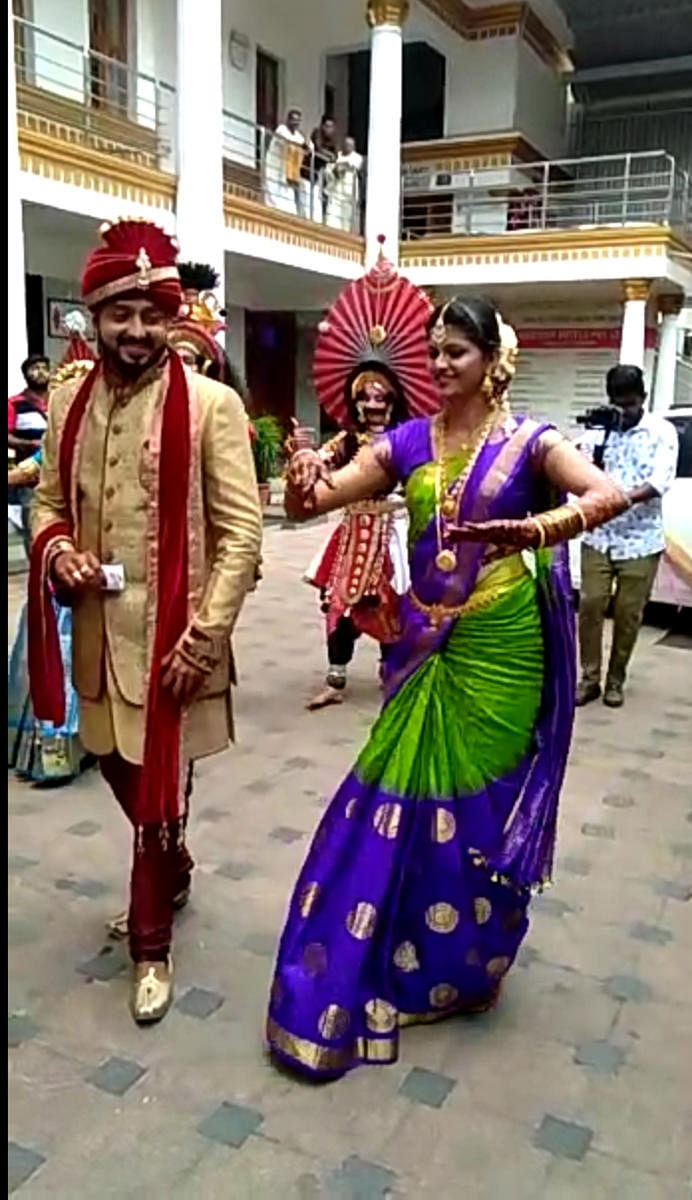 Bride Shruthi dances along with Yakshagana artistes while entering the marriage hall on the day of her wedding at Seshanayana Hall in Udupi. Groom Chethan is also seen.