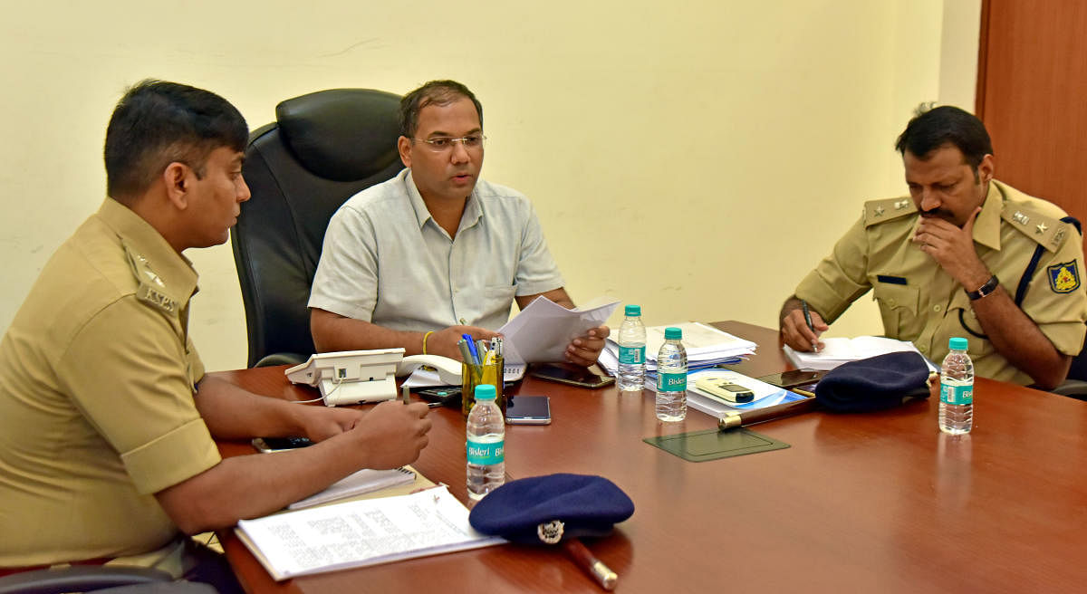 City Police Commissioner Sandeep Patil replies to a caller's question during the weekly phone-in programme in Mangaluru on Friday. DCP (Crime and Traffic) Lakshmi Ganesh and DCP (Law and order) Hanumantharaya look on.
