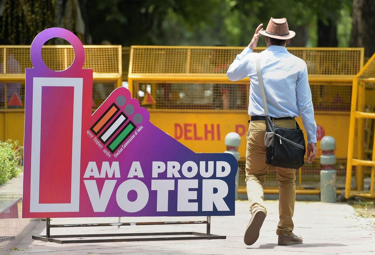 A man walk past a photo point installed at the Election Commission of India's headquarter on the eve of sixth phase polling for the Lok Sabha elections, in New Delhi, Saturday, May 11, 2019. Delhi will vote for its seven parliamentary seats on May 12. (PTI Photo)