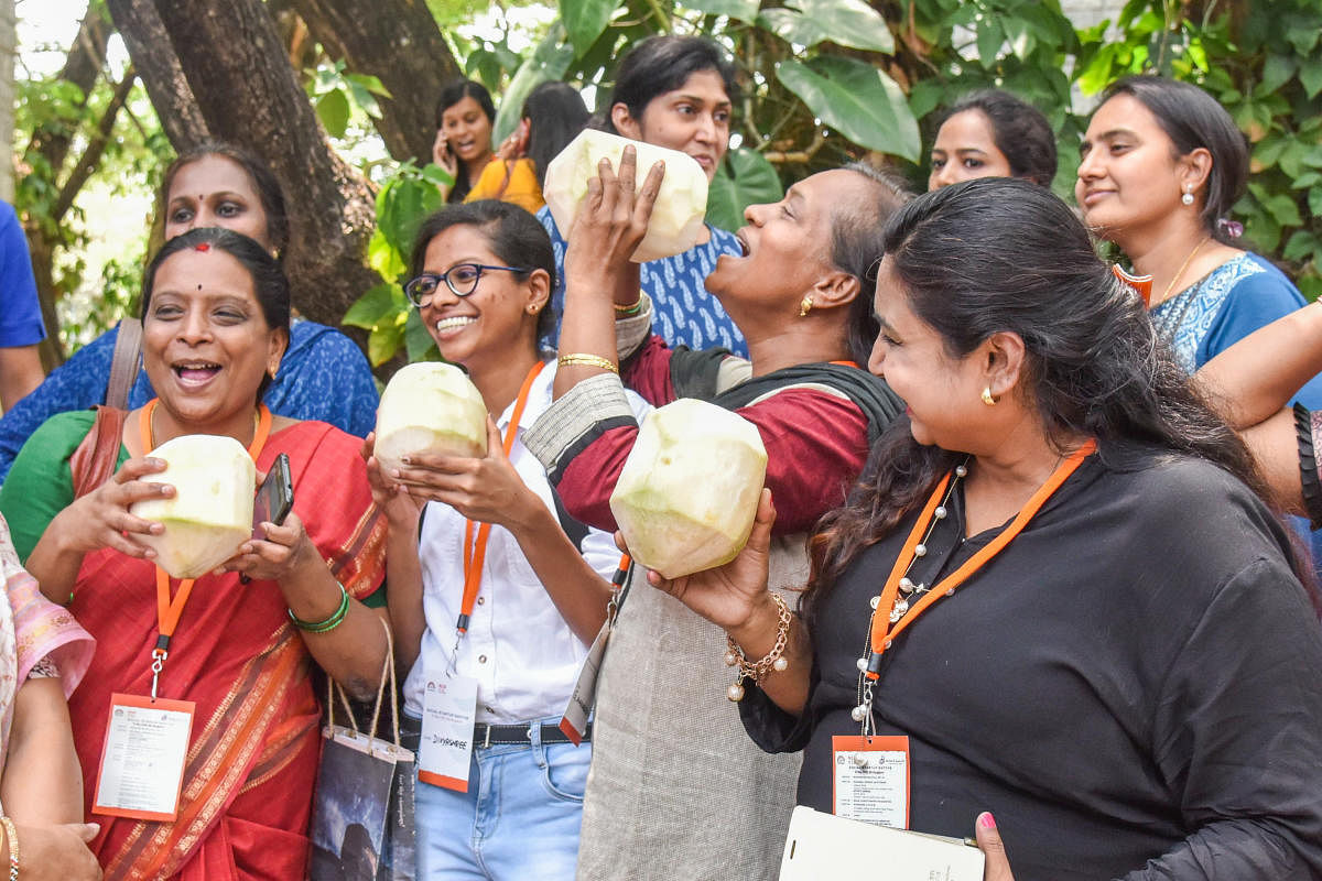 Visitors enjoy tender coconut at Econut stall. DH photo/S K Dinesh