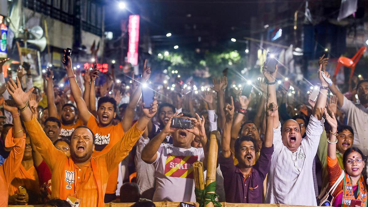 BJP supporters cheer to welcome Home Minister and BJP leader Rajnath Singh upon his arrival for election campaign in support of party candidate Rahul Sinha for Kolkata North constituency seat in Kolkata, Friday, May 10,2019. (PTI Photo)