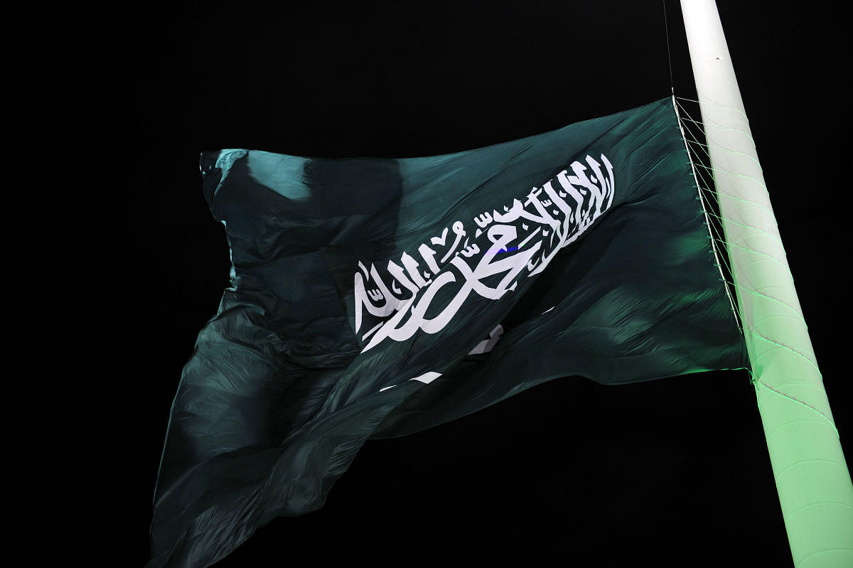 In this file photo taken on September 23, 2014, the flag of Saudi Arabia is hoisted onto the world's tallest flagpole in Jeddah. - The US Commission on International Religious Freedom on April 26, 2019, urged action against ally Saudi Arabia after