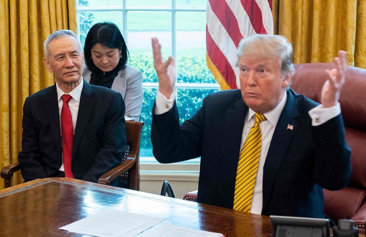 (FILES) In this file photo taken on April 4, 2019, US President Donald Trump (R) speaks during a trade meeting with China's Vice Premier Liu He (L) in the Oval Office at the White House in Washington, DC. - Trump urged patience in trade talks with China o