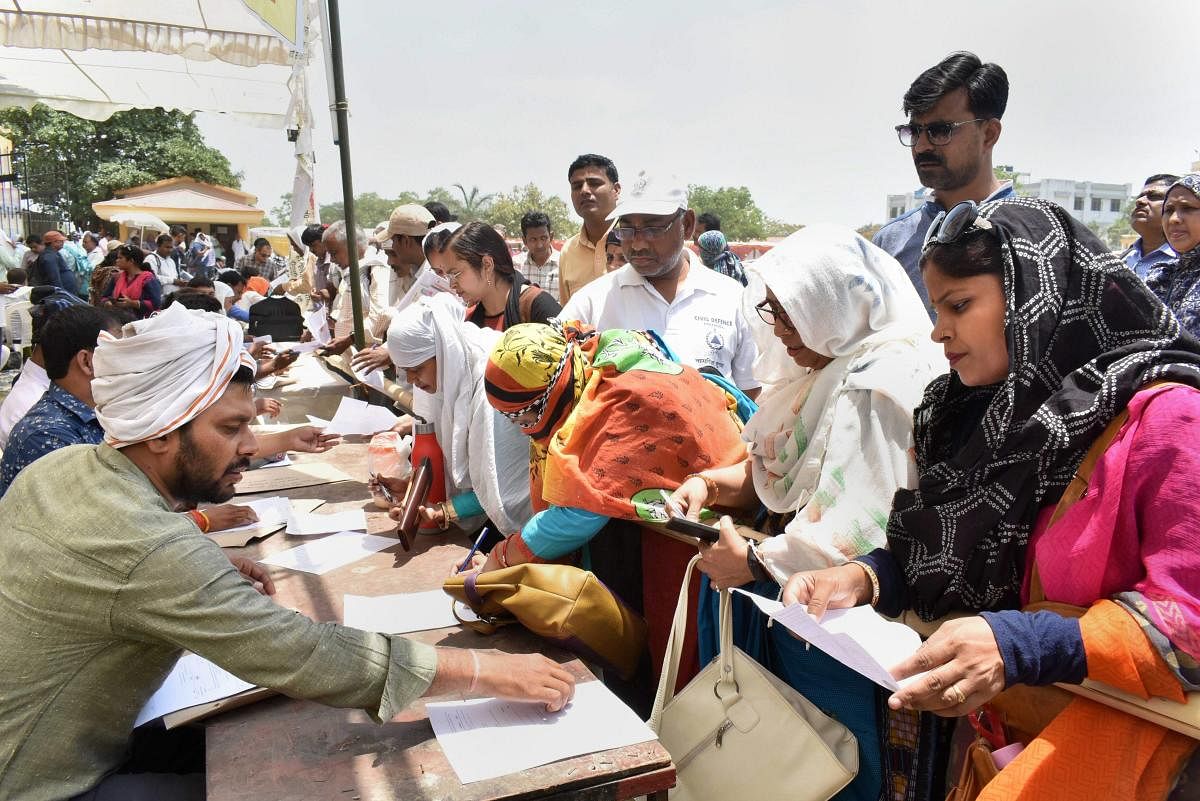 Polling officers collect EVMs ahead of the sixth phase of Lok Sabha polls, in Prayagraj. (PTI Photo)