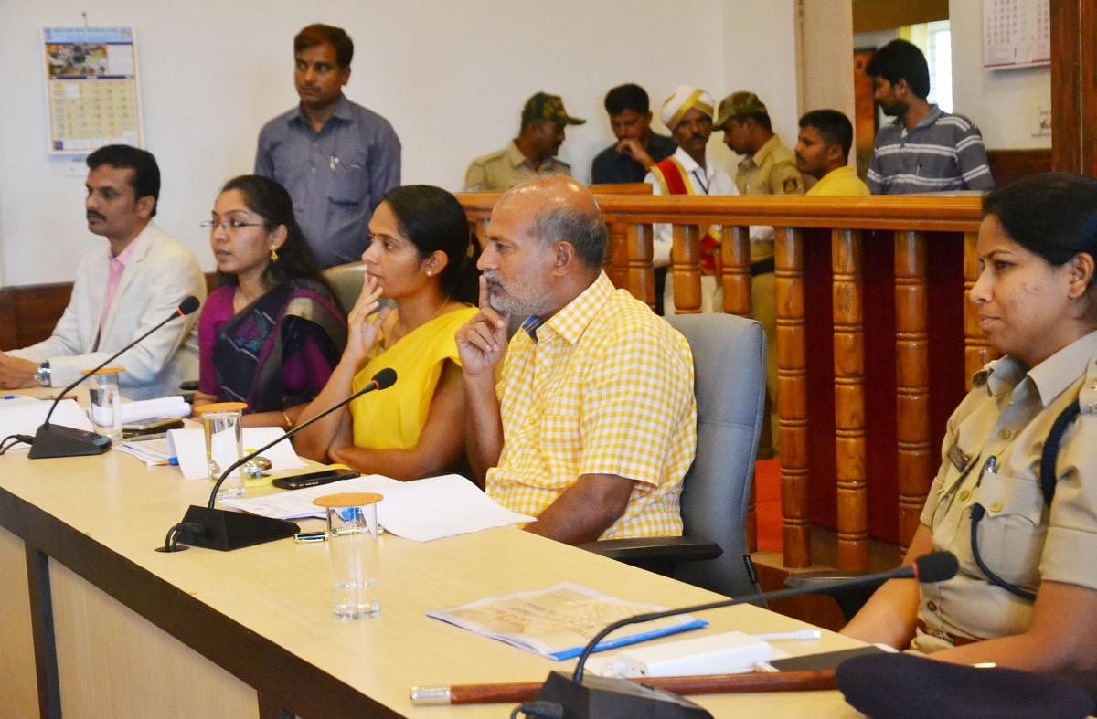 District In-charge Minister Sa Ra Mahesh chairs a meeting in Madikeri on Saturday.