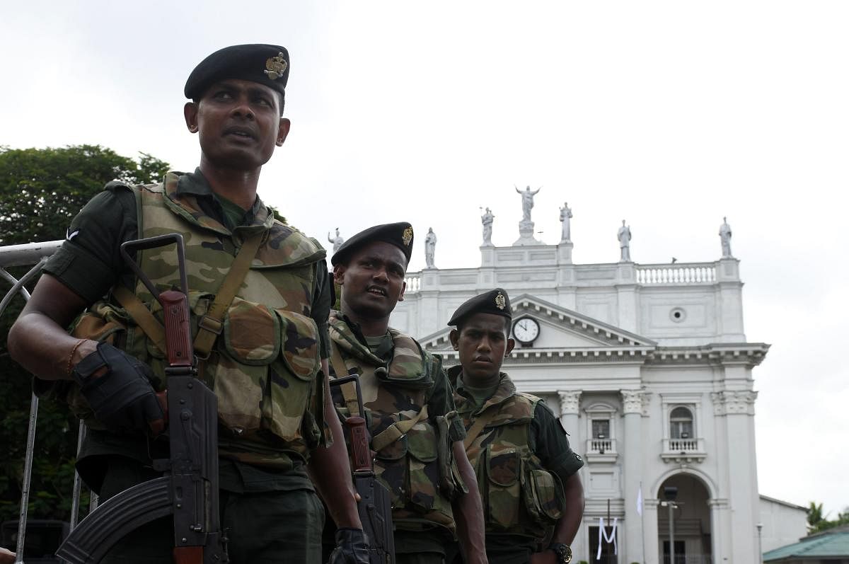 Sri Lankan Army soldiers stand guard at the St Lucia's Cathedral during a holy mass held to bless the victims of Easter Sunday attacks in Colombo. (AFP Photo)