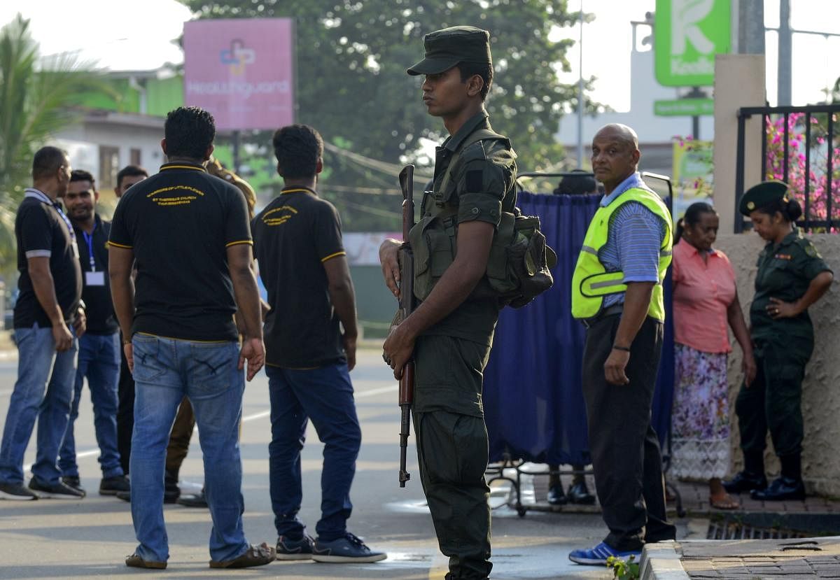A Sri Lankan Army soldier stands guard outside the St. Theresa's church as the Catholic churches hold services again after the Easter attacks in Colombo on May 12, 2019. - Thousands of Catholics attended mass in Sri Lanka's capital Colombo on May 12 amid