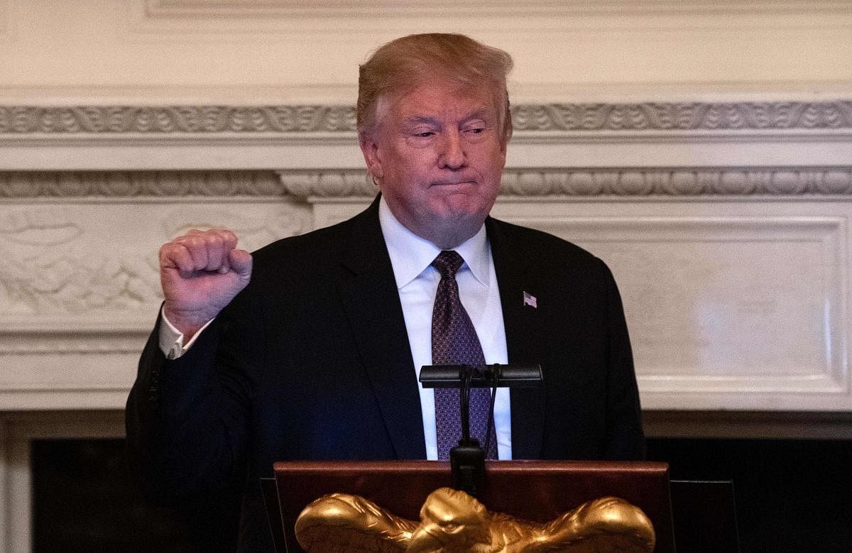 US President Donald Trump clenches his fist after speaking at an iftar, the meal that breaks the sunrise to sundown fast of Muslims celebrating Ramadan, at the White House in Washington DC on May 13, 2019. (AFP)
