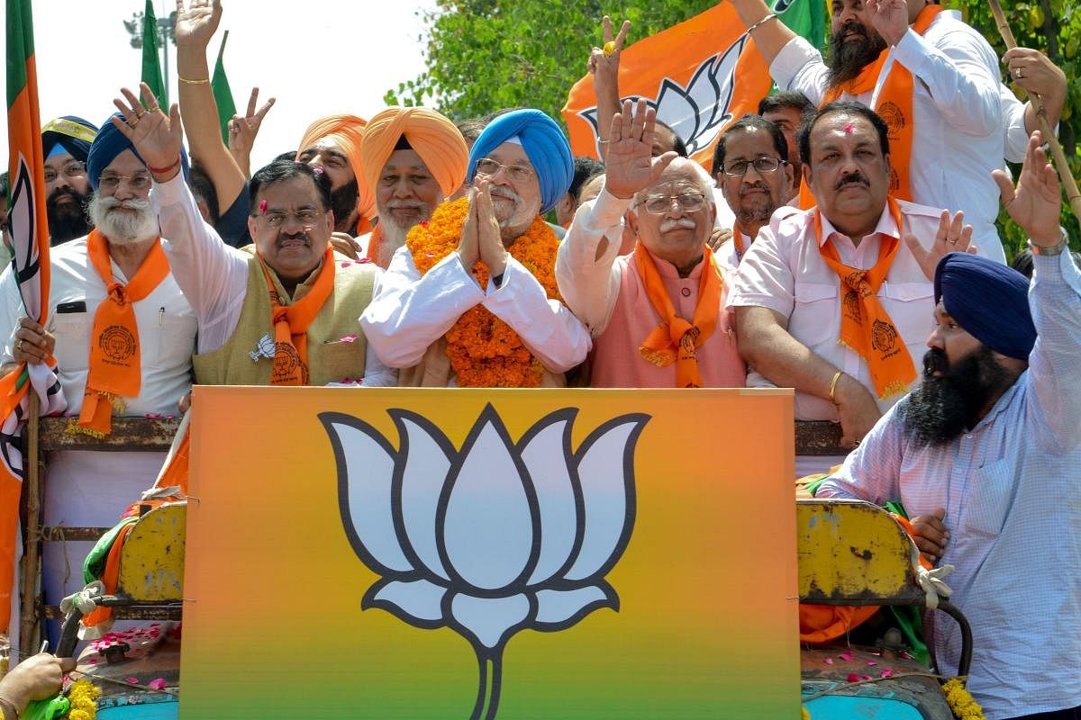 Union Minister and Bharatiya Janata Party (BJP) candidate for Amritsar's parliament seat Hardeep Singh Puri (C), Haryana Chief Minister Manohar Lal Khattar (C-R), BJP national secretary, Tarun Chugh (C-L), BJP Punjab Chief Shwait Malik (2R), gesture to po