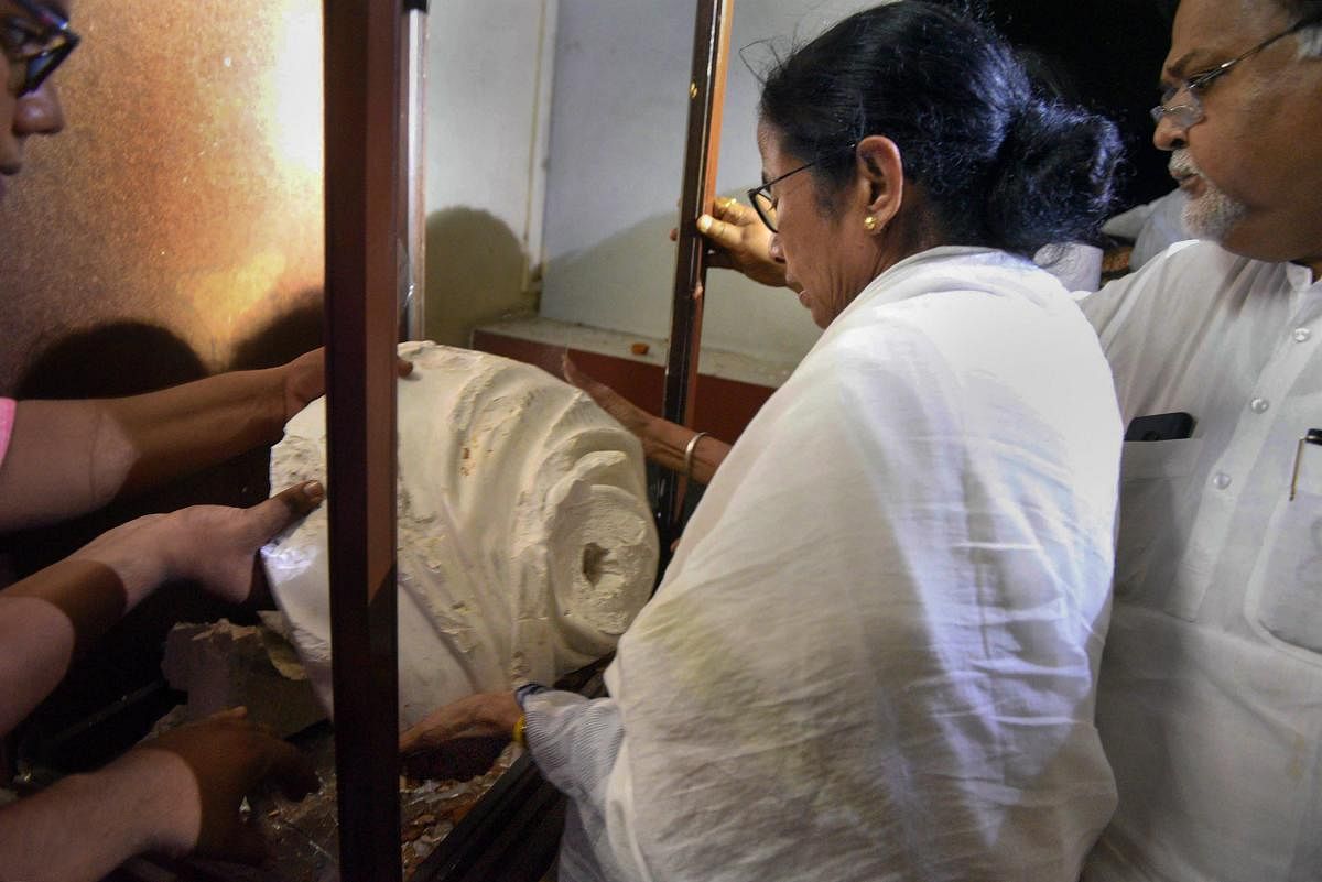 West Bengal Chief Minister Mamata Banerjee inspects the vandalised statue of Bengali writer and philosopher Ishwar Chandra Vidyasagar, after the clashes that broke out at BJP President Amit Shah's roadshow, in Kolkata, Tuesday night, May 14, 2019. (Handout Photo/ PTI)