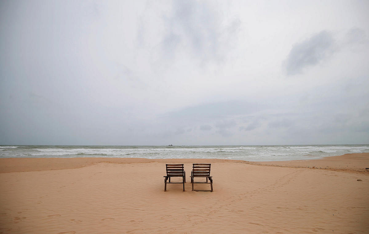Empty sunbathing chairs are seen on a beach near hotels in a tourist area in Bentota (Photo Reuters).