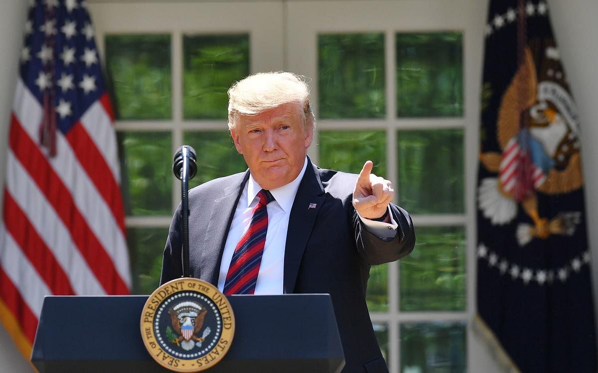 US President Donald Trump gestures as he delivers remarks on immigration at the Rose Garden of the White House in Washington, DC on May 16, 2019. - President Donald Trump called for radical immigration reform to favour skilled, English-speaking workers ov