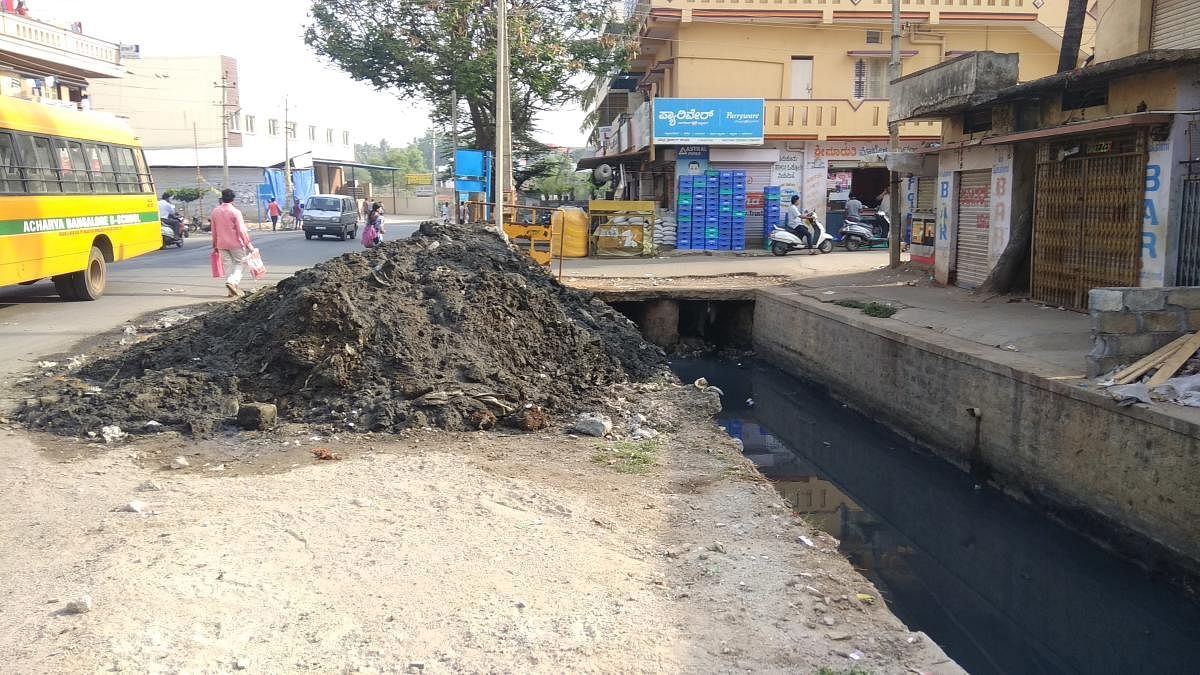 Silt from drain removed but pushed back by pre-monsoon showers