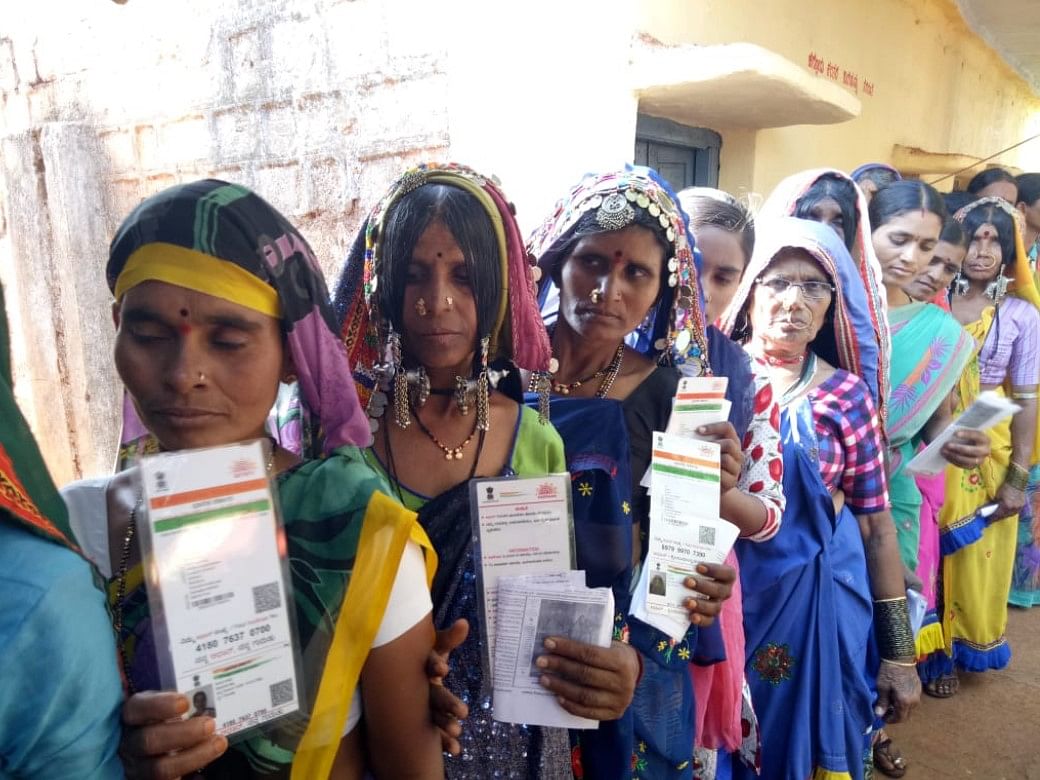 Lambani women wait in line to cast their votes for byelection to Chincholi Assembly segment at Shadipur Tanda. (DH Photo)