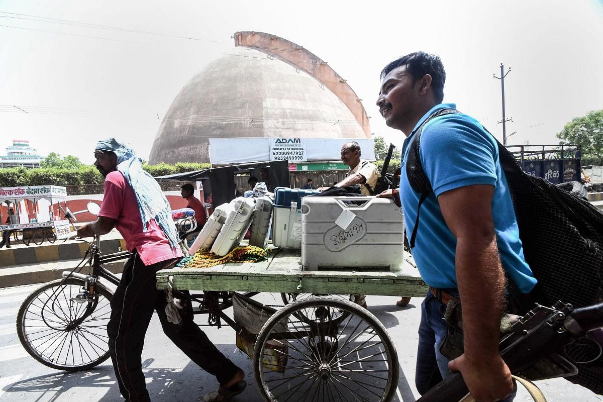 Patna: A worker carries Electronic Voting Machines (EVM) and VVPAT machines on the eve of seventh and last phase of Lok Sabha polls, in Patna, Saturday, May 18, 2019. (Photo PTI)