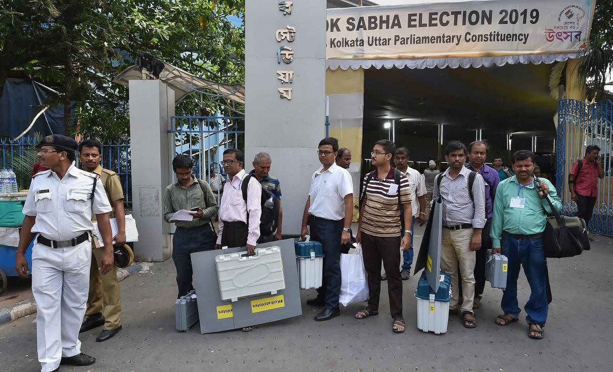 Kolkata: Election officials wait for a bus with EVM, VVPAT machines and other equipments ahead of the seventh and last phase of Lok Sabha polls, in Kolkata. (Photo PTI