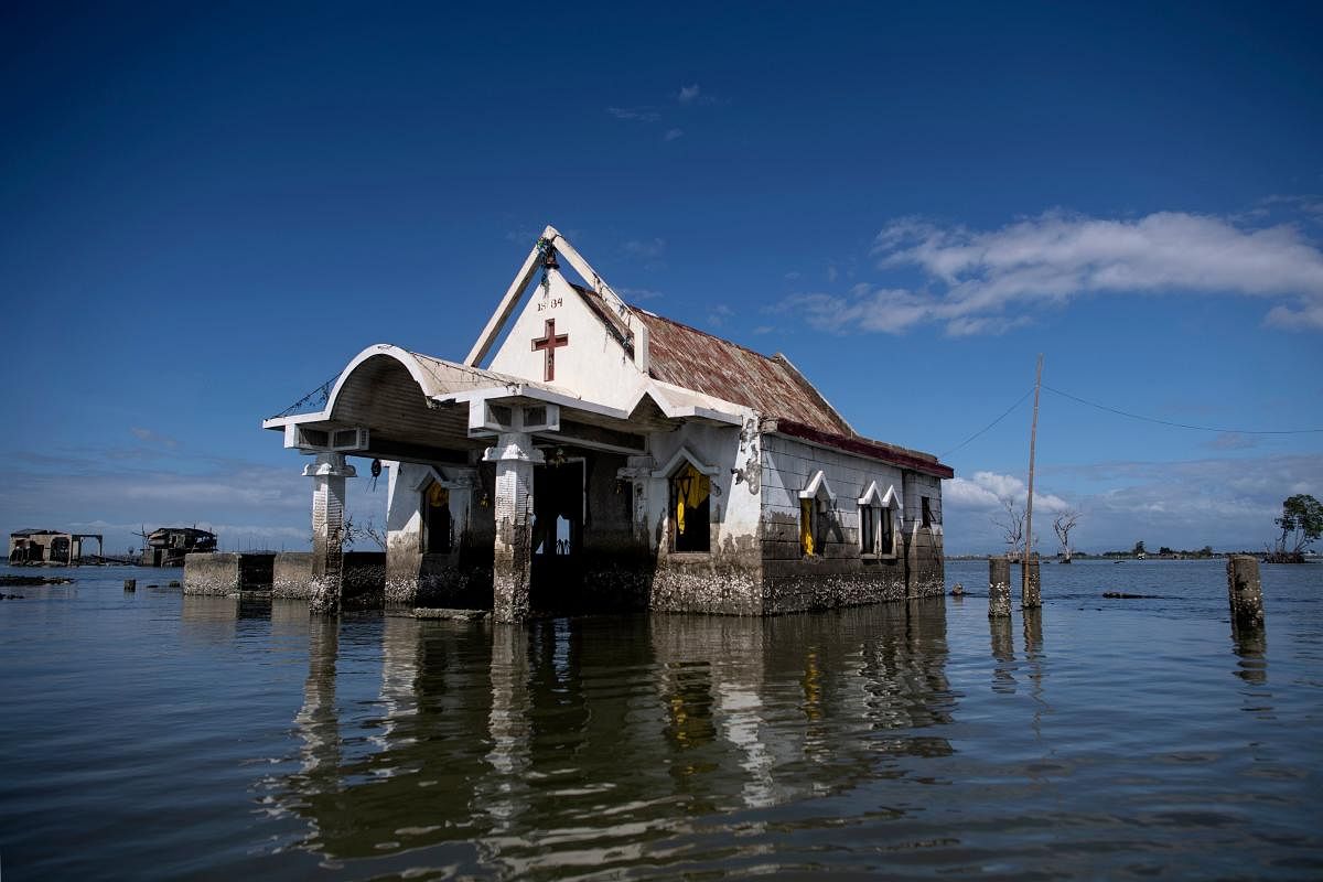 This photo taken on January 11, 2019 shows a chapel amid encroaching bay waters in Sitio Pariahan, Bulacan. - Areas north of Manila like the provinces of Pampanga and Bulacan have sunk four-six centimetres (1.5-2.4 inches) a year since 2003, according to satellite monitoring. The creeping bay waters put people and property at risk, while the threat is amplified by high-tides and flooding brought by the roughly 20 storms that pound the archipelago every year. (Photo AFP) 