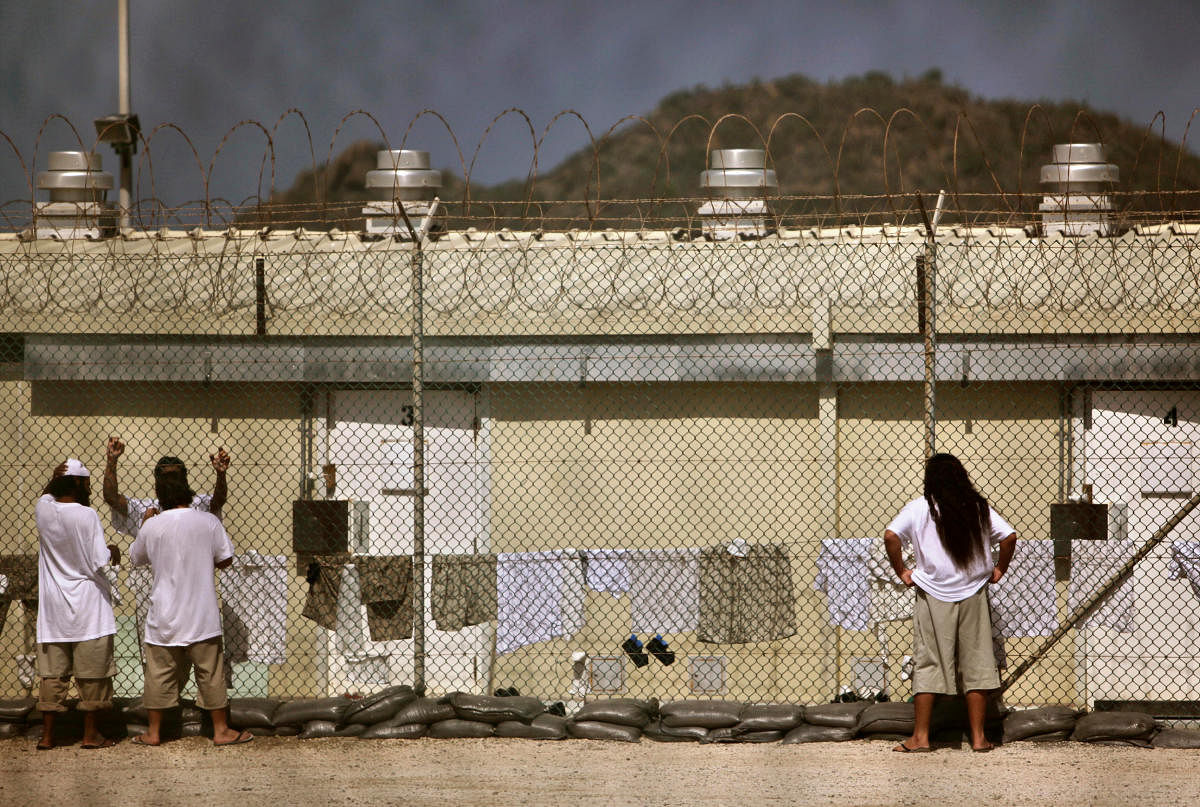 Detainees talk together inside the open-air yard at the Camp 4 detention facility at Guantanamo Bay U.S. Naval Base in Cuba, May 31, 2009. (REUTERS File Photo)