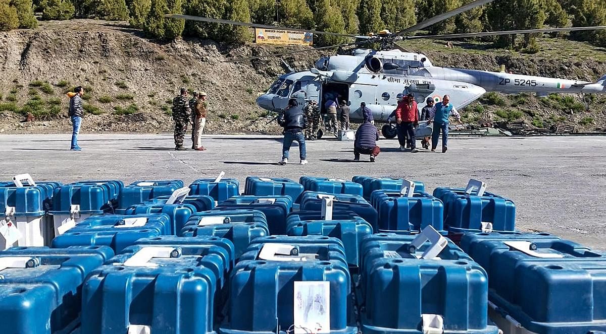 EVMs and VVPAT machines being unloaded from a Border Security Force helicopter at Stingri helipad for further transportation to the strong room in Lahaul and Spiti district on May 20, 2019. (PTI Photo) 