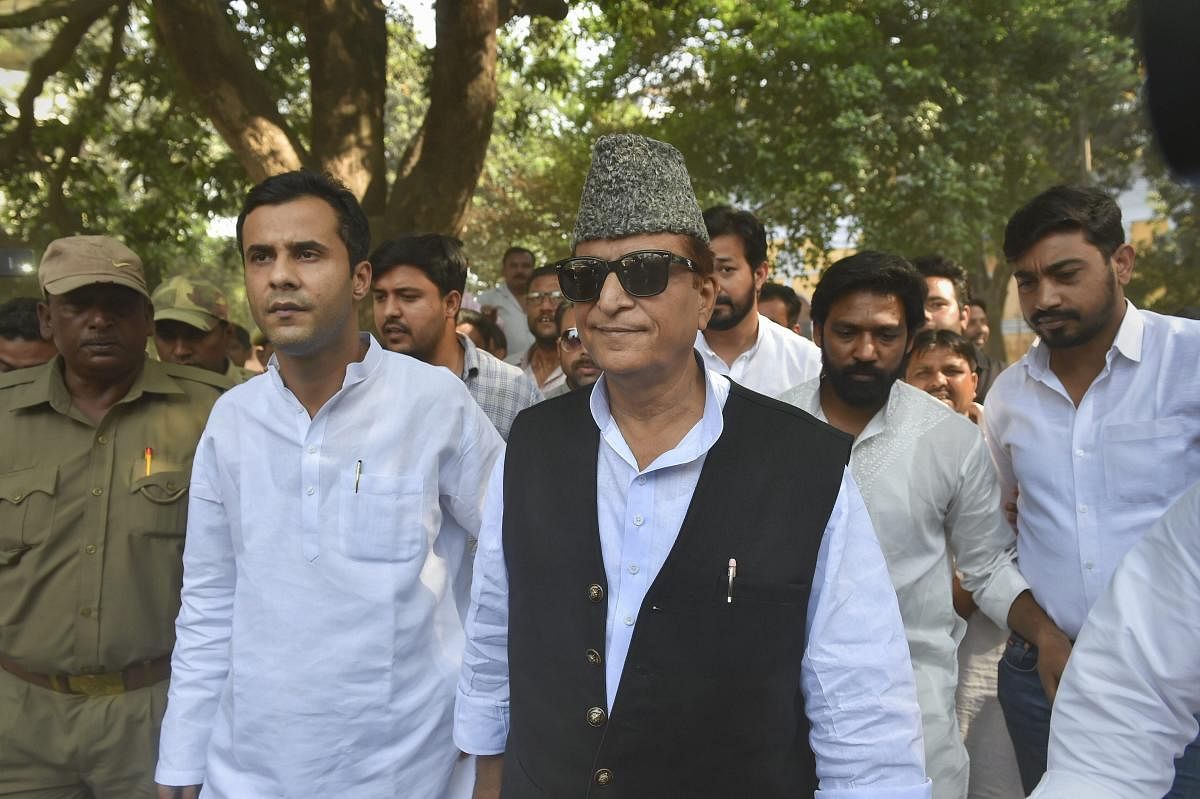 Samajwadi Party (SP) candidate from Rampur, Azam Khan, and his son Adeeb Azam Khan arrive to cast their vote, during the third phase of the 2019 Lok Sabha elections. (PTI File Photo)
