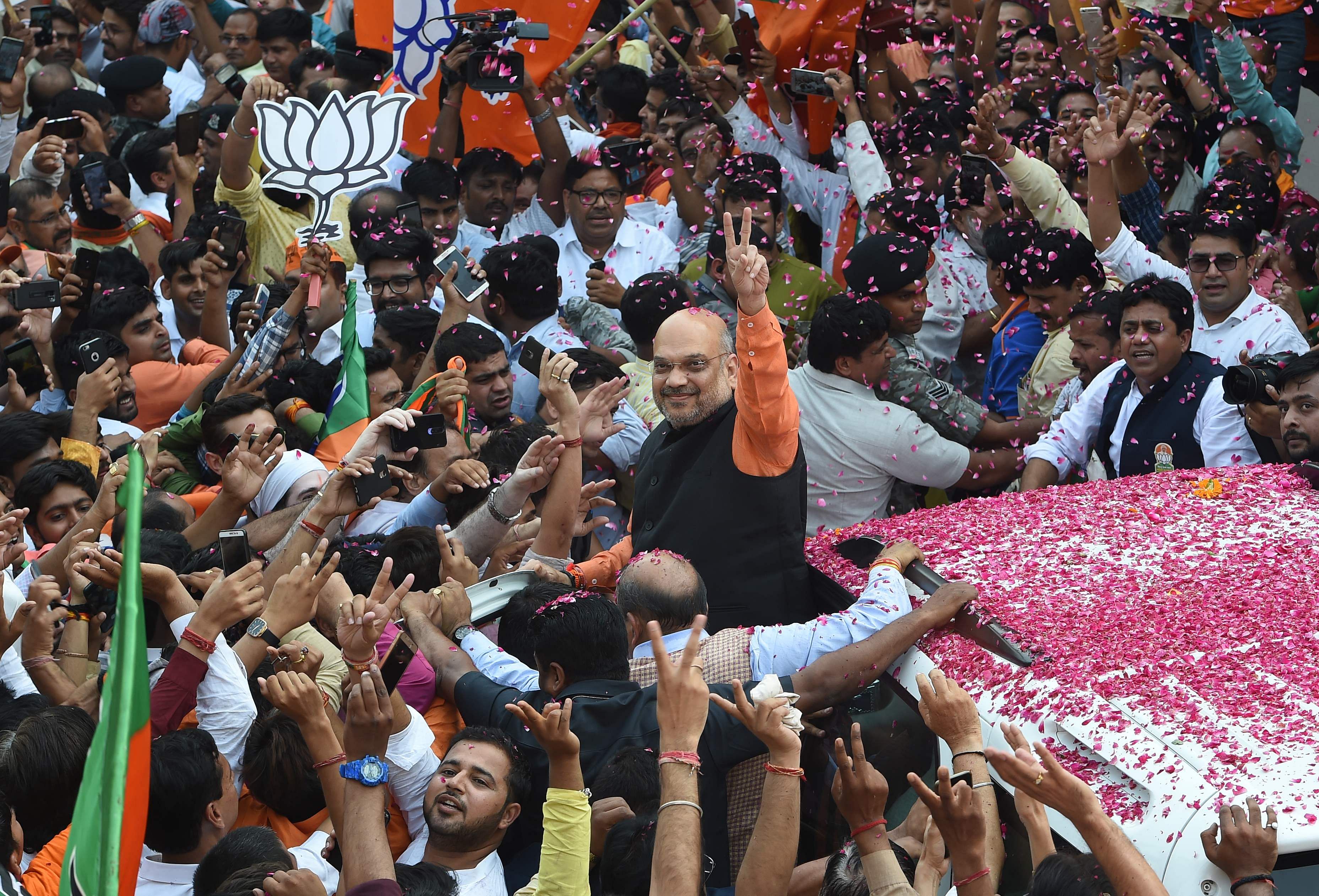 Amit Shah (C), president of the ruling Bharatiya Janata Party (BJP), gestures to supporters during victory celebrations in the Indian national elections in New Delhi on May 23, 2019. - India's Prime Minister Narendra Modi claimed victory May 23 in the country's elections, promising an "inclusive" future after his Hindu nationalist party appeared headed for a landslide win. (Photo by AFP)
