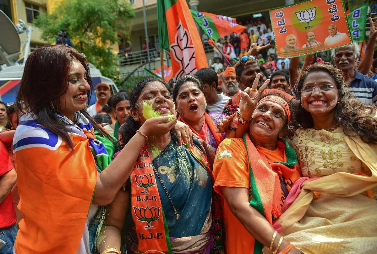  BJP supporters celebrate the party's lead during the counting of votes for Lok Sabha elections 2019, in Bengaluru, Thursday, May 23, 2019. (PTI Photo)
