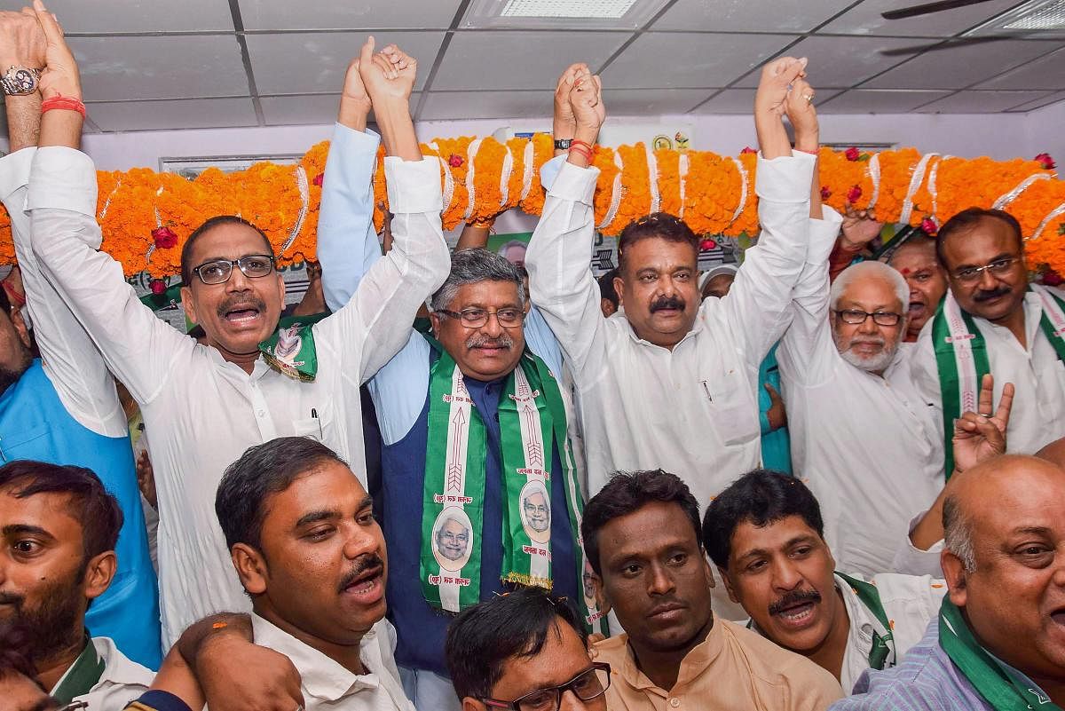 Patna: Union minister and BJP candidate from Patna Sahib Ravi Shankar Prasad being garlanded by Janta Dal United party supporters during his visit to JD-U office as part of an election campaign for the Lok Sabha polls, in Patna, Sunday. (PTI Photo)