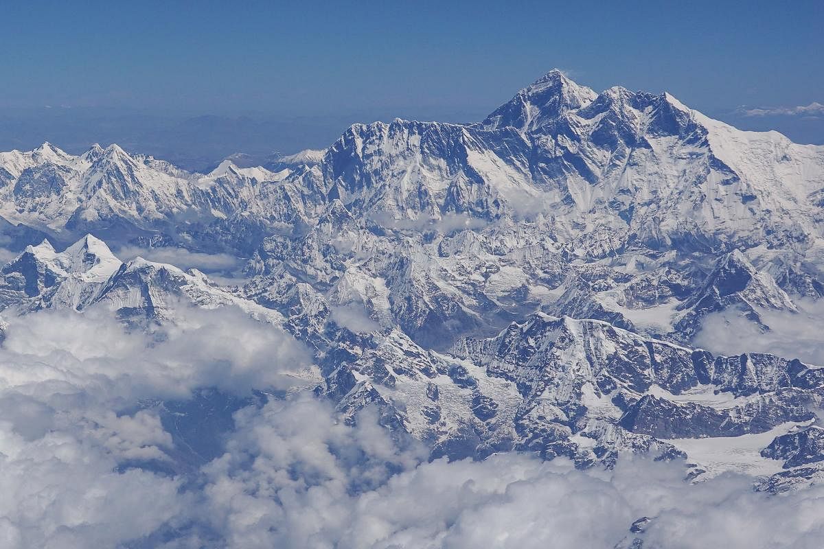 This photo taken on April 27, 2019 shows an aerial view of Mount Everest (centre R) taken during a flight from Nepal to Bhutan. (Photo by Sarah LAI / AFP)
