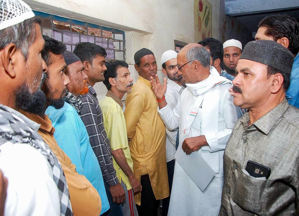 Congress candidate for Bhopal seat Digvijaya Singh interacts with voters at a polling booth during the sixth phase of Lok Sabha polls, in Bhopal. (PTI Photo)