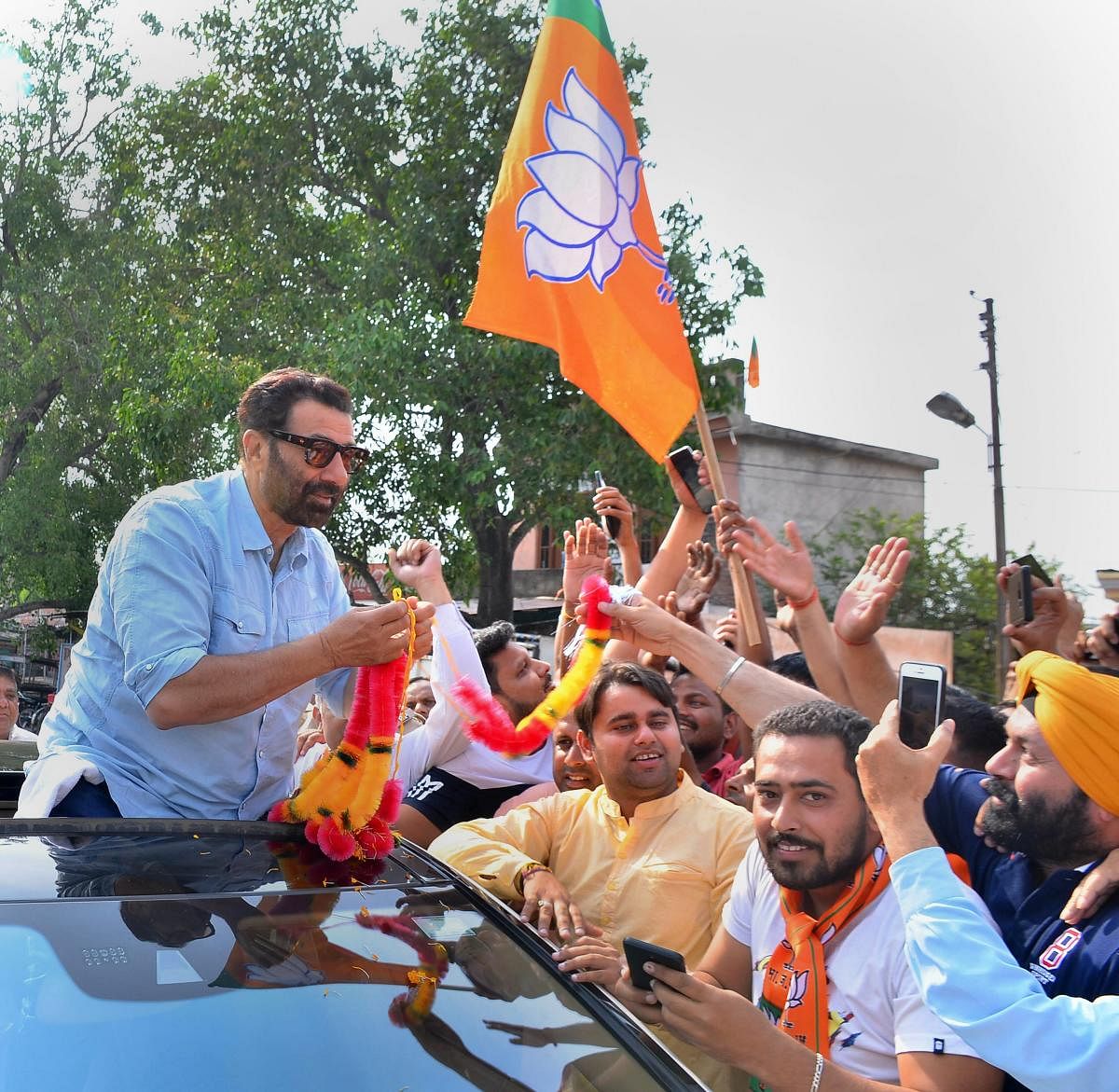 Kathua: BJP's Gurdaspur seat candidate Sunny Deol greets party supporters during a roadshow ahead of the seventh and final phase of Lok Sabha polls. (PTI File Photo)