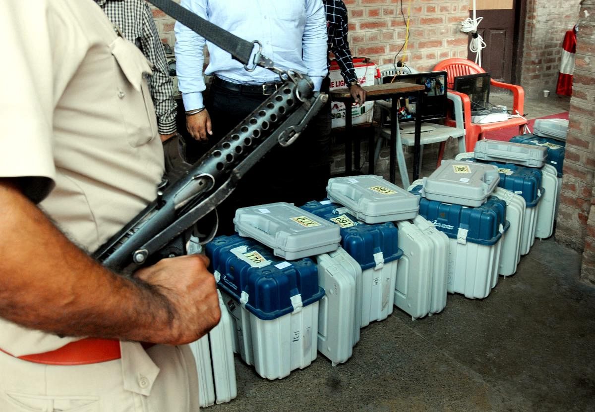 Police officers stand guard near Electronic Voting machines (EVM) and Voter Verifiable Paper Audit Trail (VVPAT) machines during seventh phase of Lok Sabha elections in Amritsar on May 18, 2019. PTI 