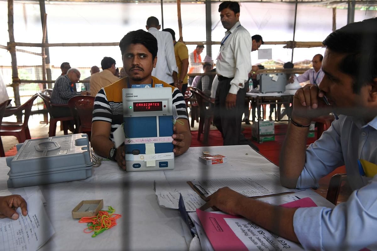 An Indian election official shows an open Electronic Voting Machine (EVM) to polling agents at a counting centre (Photo AFP)